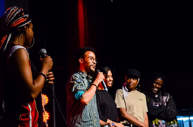 Image of Ryzard speaking at an exhibition event